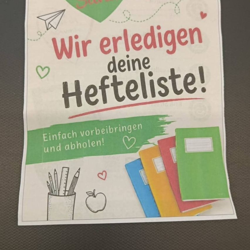 A colorful flyer with the text 'We redeem your wish list!' in red. Below it, there are illustrations of notebooks, a pencil case, and an apple. The background is white with green and red accents.