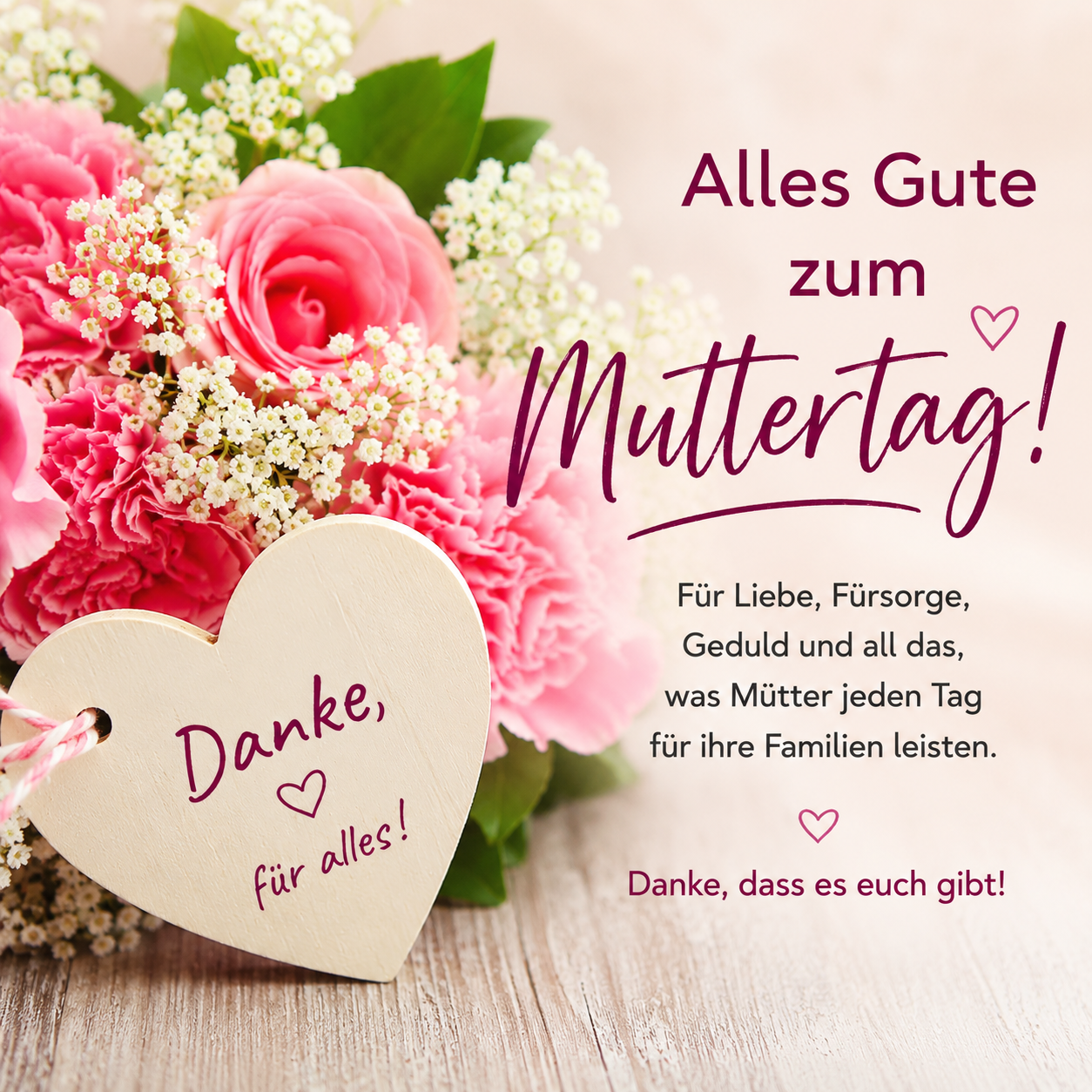 A heart-shaped wooden tag with a message 'Thank you for everything' is placed in a bouquet of pink flowers. The message is written in purple. The bouquet is surrounded by a wooden surface.