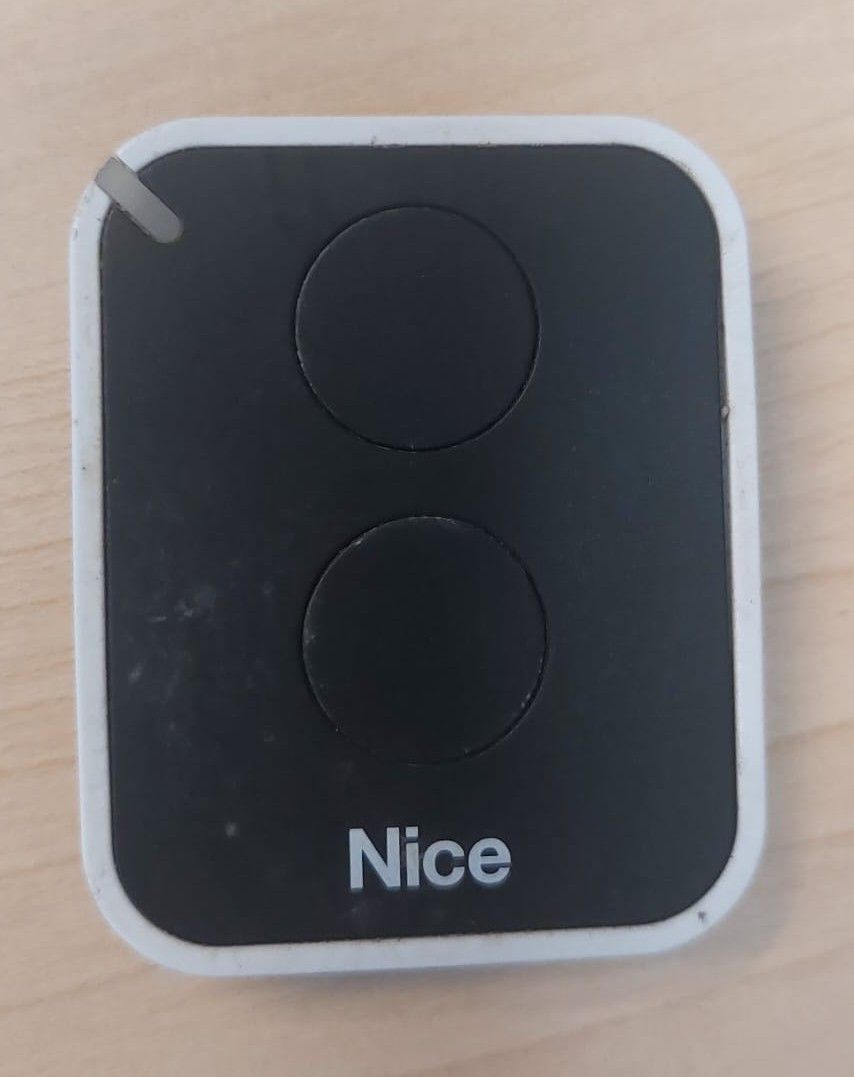 A black and white remote control with two circular buttons and the word 'Nice' printed in white.