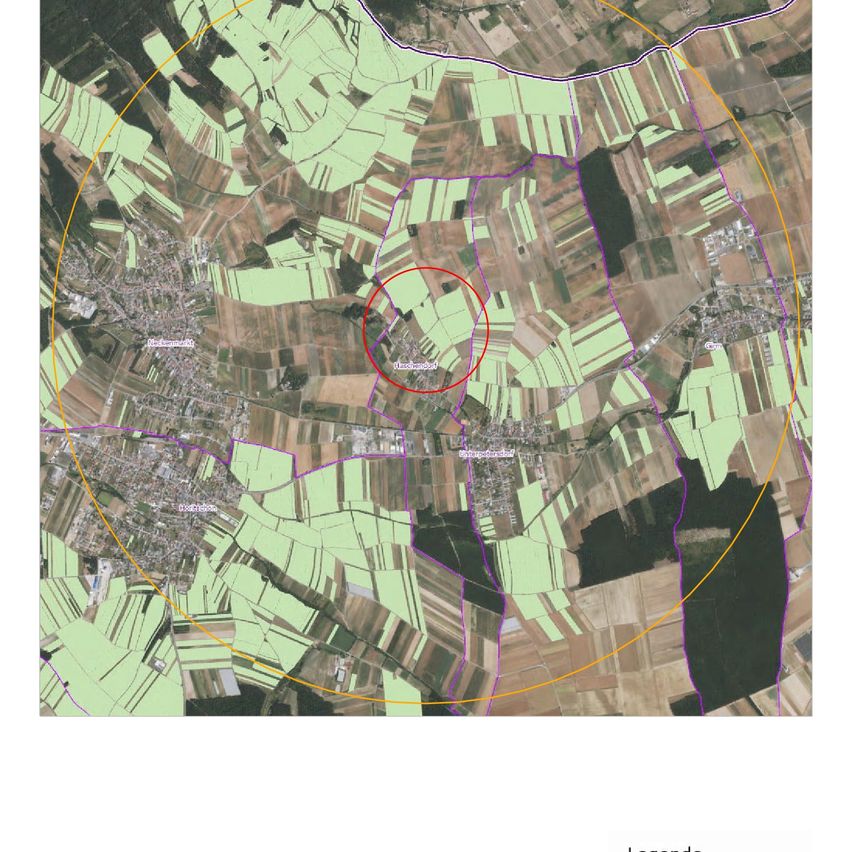 Aerial view of a rural area with green fields, a red circle highlighting a specific location, and various colored lines indicating boundaries.