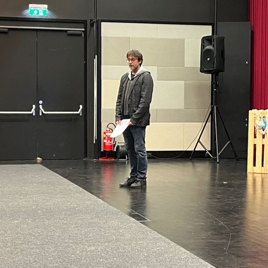 Floor, Person, Solo Performance, Coat, Adult, Male, Man, Jeans, Flooring, Shoe