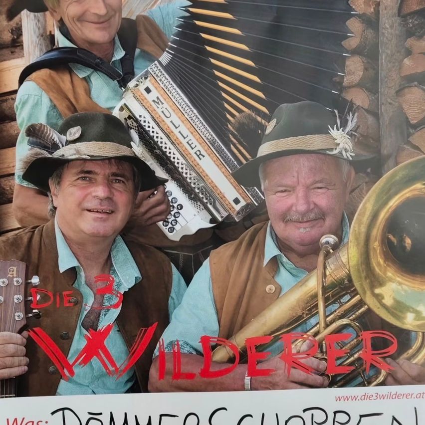 Three men dressed in traditional attire, smiling, with one holding a guitar, one an accordion, and one a tuba. The text 'Die 3 Wilderer' is prominently displayed in red.