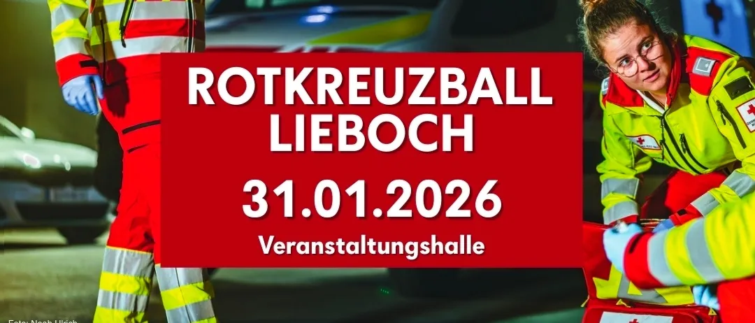 Ein roter Banner mit weißem Text zeigt 'ROTKREUZBALL LIEBOCH 31.01.2026'. Zwei Personen in roten und gelben Uniformen stehen neben einem roten Fahrzeug.