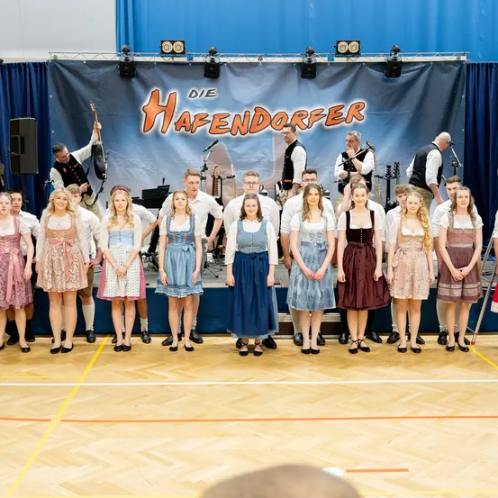 Stage, Person, Clothing, Dress, Microphone, Group Performance, Groupshot, Shorts, Shoe, Crowd
