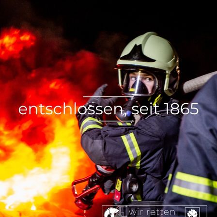 Ein Feuerwehrmann mit Helm und Maske steht vor einem brennenden Feuer. Der Text 'entschlossen, seit 1865' ist in der Mitte des Bildes angezeigt.