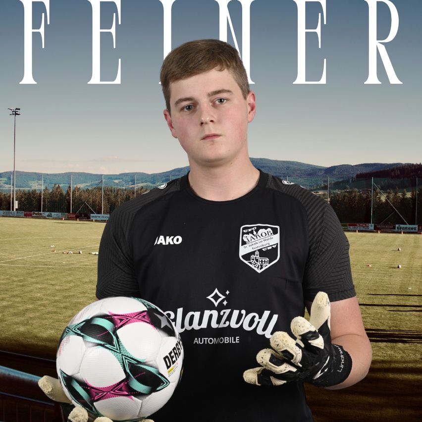 A young man in a soccer jersey, holding a soccer ball, stands in front of a soccer field with a blurry background.