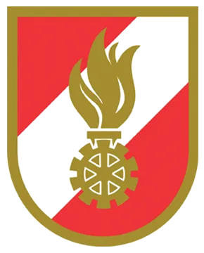 Ein Schild, der durch eine diagonale Linie von der unteren linken zur oberen rechten Ecke geteilt ist, mit einem roten Hintergrund unten und einem schwarzen oben. Eine goldene Flamme, die aus einem goldenen Zahnrad in der Mitte aufsteigt.