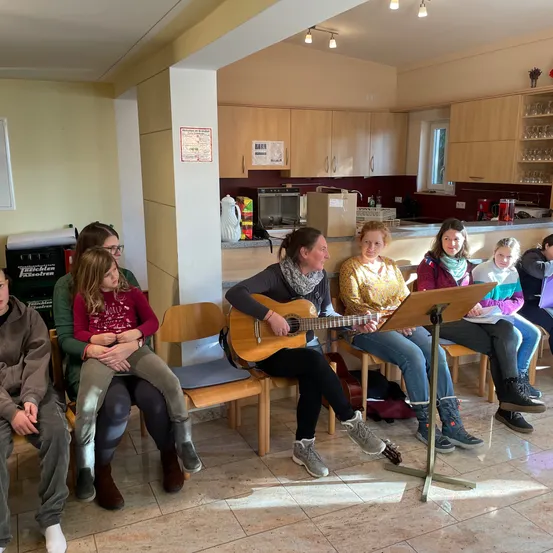 People, Person, Couch, Adult, Female, Woman, Guitar, Guitarist, Pants, Jeans