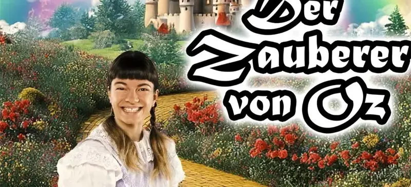 Eine junge Frau lächelt vor einem farbenfrohen Garten mit einem Schloss im Hintergrund, der Text lautet 'Der Zauberer von Oz'.