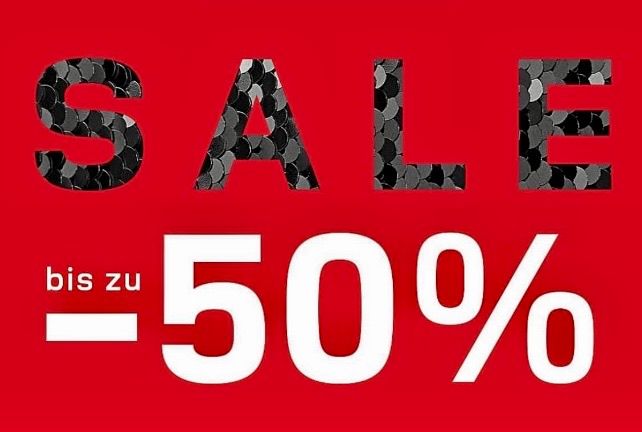 A red poster with the word SALE in black and white letters. It has a percentage sign and the text bis zu -50% underneath.