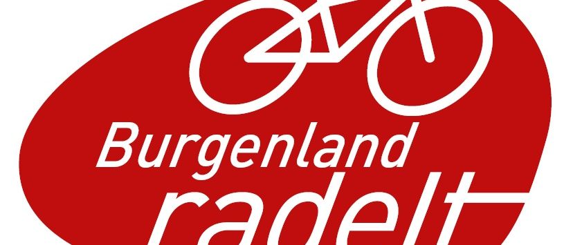 Das Burgenland radelt Logo zeigt einen roten Oval mit einem weißen Fahrrad darin, die Worte 'Burgenland radelt' sind in weißer Schrift darunter geschrieben.