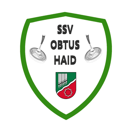 Das Logo zeigt einen grünen Schild mit zwei silbernen Objekten auf jeder Seite und dem Text 'SSV Obtus Haid'. Darunter befindet sich ein Wappen mit rotem und grünem Hintergrund und einem Logo in der Mitte.
