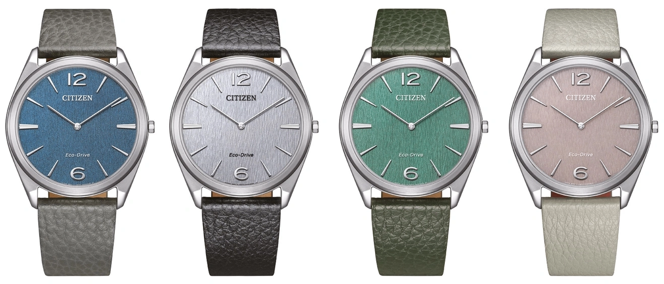 Zwei Citizen-Uhren mit Lederarmbändern. Die linke hat ein schwarzes Armband und ein silbernes Zifferblatt, die rechte ein grünes Armband und ein grünes Zifferblatt. Beide haben Eco-Drive-Technologie.