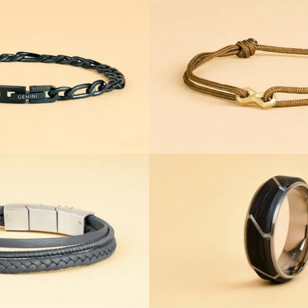 Vier verschiedene Arten von Armbändern werden gezeigt. Ein schwarzes Kettenarmband, ein braunes Tau, ein graues geflochtenes und ein schwarzes und silbernes Armband.