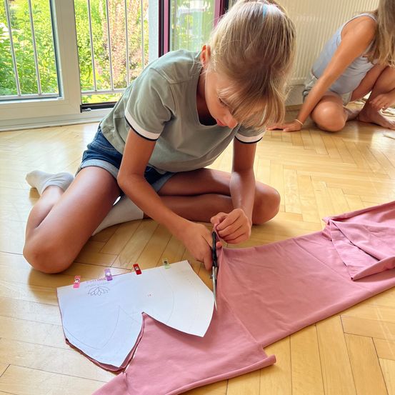 Bild enthält, Floor, Person, Flooring, Scissors, Clothing, Shorts, Hosiery, Sock, Face, Head