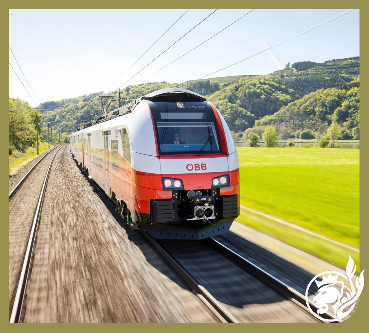 A red and white train travels along the tracks. The train is moving quickly, leaving a trail of grass in its wake. Green fields and hills are visible in the background.