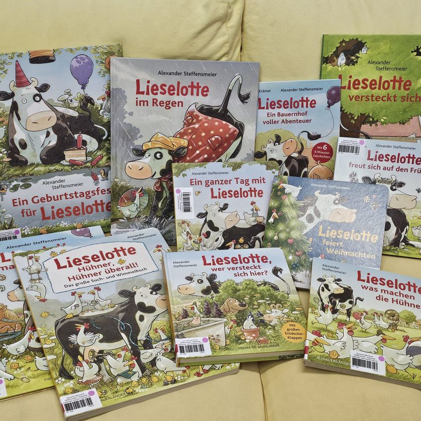 A collection of children's books titled 'Lieselotte' featuring various adventures of a cow named Lieselotte. The books are displayed on a light-colored surface.