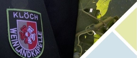 Ein Nahaufnahme eines Polizeiuniformpatches mit der Aufschrift 'KLOECH' und einem roten und weißen Emblem auf schwarzem Hintergrund.
