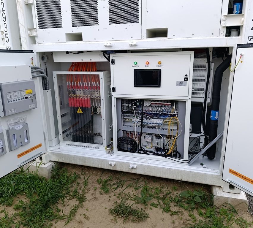 An open electrical panel with multiple wires and a control panel with three status indicators: power, run, and fault.