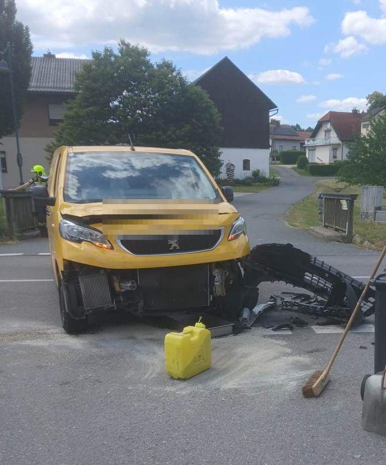A yellow Peugeot van is wrecked on the side of the road with debris and a yellow fuel can on the ground.