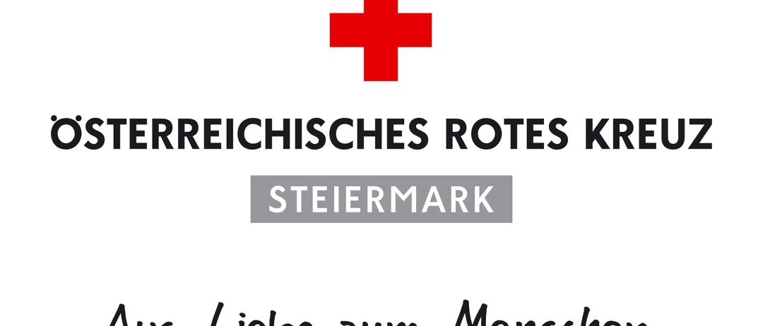 Ein weißer Hintergrund mit einem roten Kreuz in der Mitte, darüber steht 'Kreischisches Rotes Kreis' und darunter 'Steiermark'. Unter dem Text steht in kursiver Schrift 'als Liebe zum Mensch'.