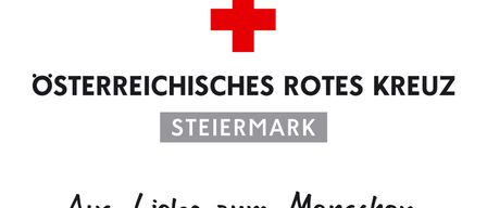 Ein weißer Hintergrund mit einem roten Kreuz in der Mitte, darüber steht 'Kreischisches Rotes Kreis' und darunter 'Steiermark'. Unter dem Text steht in kursiver Schrift 'als Liebe zum Mensch'.