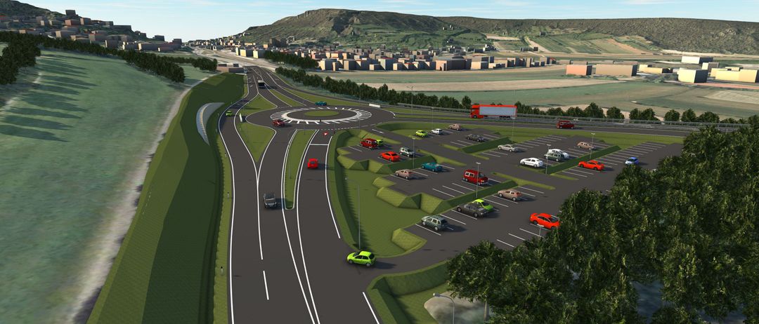 Eine Luftaufnahme einer modernen Autobahn mit mehreren Fahrspuren, einem Kreisverkehr und Autos. Ein LKW ist auf der rechten Seite, und eine Stadt ist im Hintergrund.