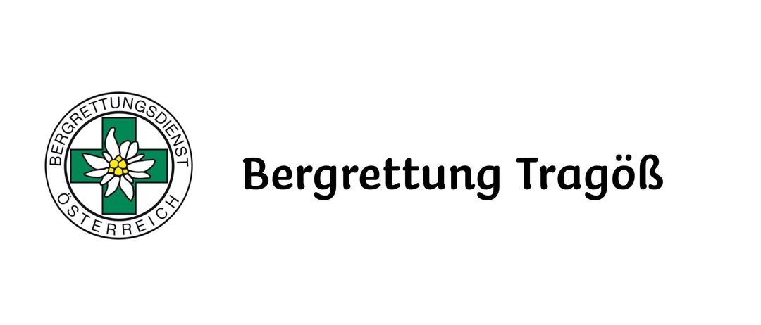 Das Bild zeigt ein Logo für Bergrettung Tragöß, eine österreichische Bergrettungsorganisation, mit einem stilisierten weißen Kreuz, einer gelben Blume in der Mitte und dem Wort 'Bergrettung Tragöß' in Fettschrift darunter.