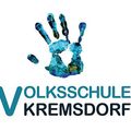 Logo der Volksschule Kremsdorf mit einem stilisierten blauen Handabdruck und darunter dem Text 'VOLKSSCHULE KREMSDORF'.