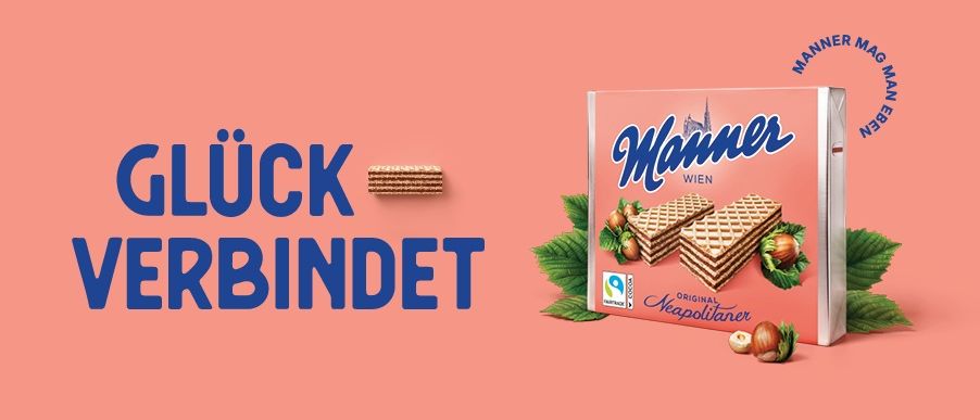 Ein Bild einer Schachtel Manner-Waffeln, einer berühmten österreichischen Marke, auf einem pfirsichfarbenen Hintergrund mit dem Text 'Gluck Verbundet' und einem Logo.