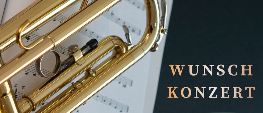 Eine Trompete ruht auf Musikblättern mit dem deutschen Text 'Wunsch Konzert' im Hintergrund. Die Veranstaltung ist für Freitag, den 20. März 2026 geplant.