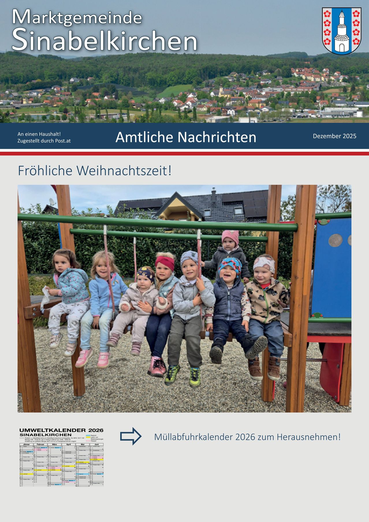 Das Bild zeigt eine Gruppe junger Kinder, die auf einer Schaukel im Spielplatz sitzen. Dahinter befindet sich ein Haus mit Schornstein und einem Baum. Der Text lautet 'Amtliche Nachrichten' und 'Frohe Weihnachtszeit!' Unter dem Bild befindet sich ein blau-weißes Banner.