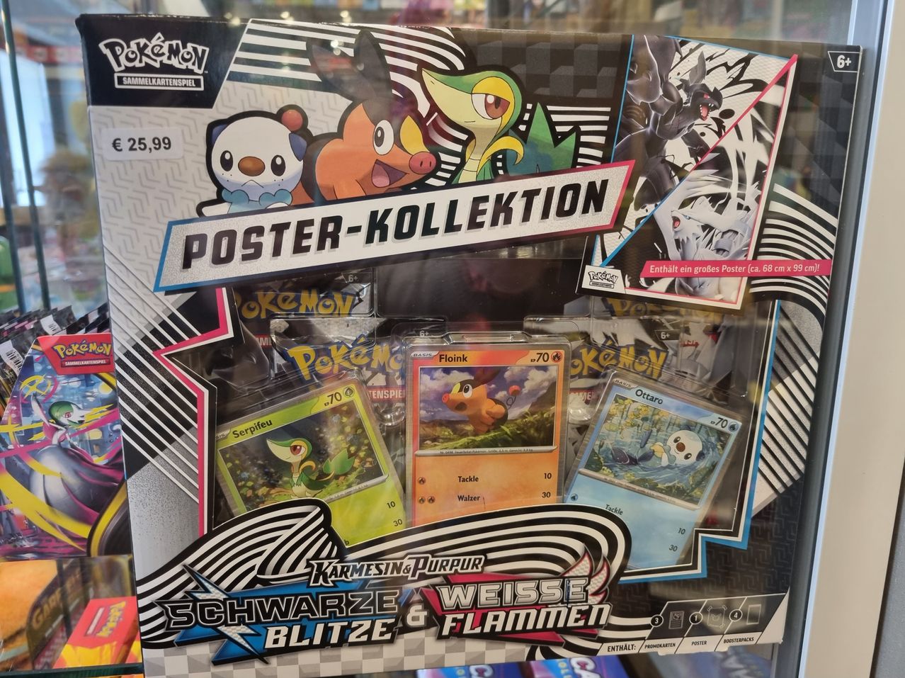 Display box for a Pokemon card game set with a poster collection. The poster is large, 68 cm by 68 cm. Inside the box, there are cards of various Pokemon characters.