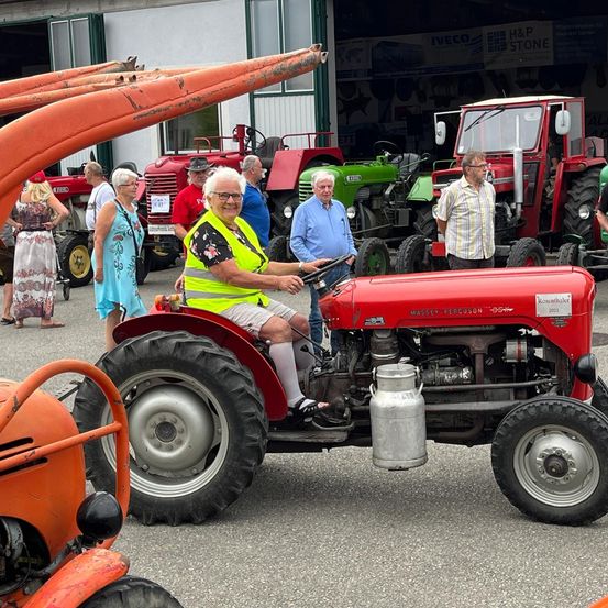 Bild enthält, Person, Worker, Adult, Male, Man, Wheel, Tire, Glasses, Shoe, Tractor