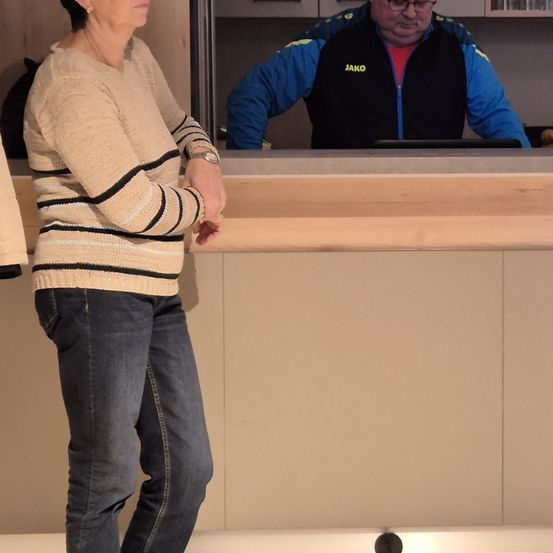 Bild enthält, Furniture, Table, Pants, Desk, Glasses, Plywood, Adult, Male, Man, Person