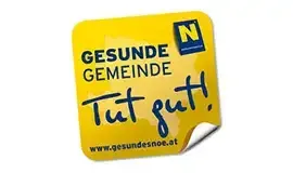 Ein gelber Aufkleber mit blauem Text, der 'GESUNDE GEMEIDE Tut gut!' und eine Website-Adresse am unteren Rand zeigt.