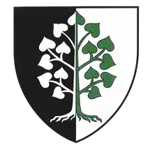 Ein heraldischer Schild mit schwarzem und weißem Hintergrund ist in zwei Abschnitte unterteilt. Der linke Abschnitt zeigt einen weißen Baum mit Blättern. Der rechte Abschnitt zeigt einen grünen Baum mit Blättern.