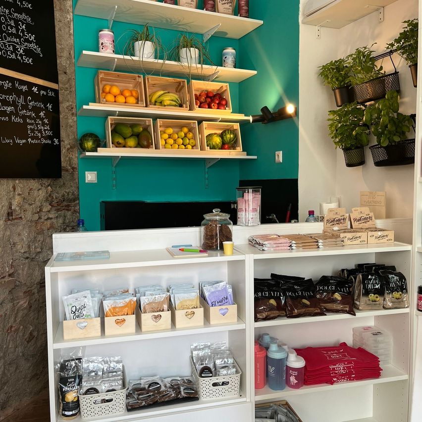 Bild enthält, Shelf, Indoors, Shop, Grocery Store, Market, Cup, Plant, Supermarket, Furniture, Blackboard