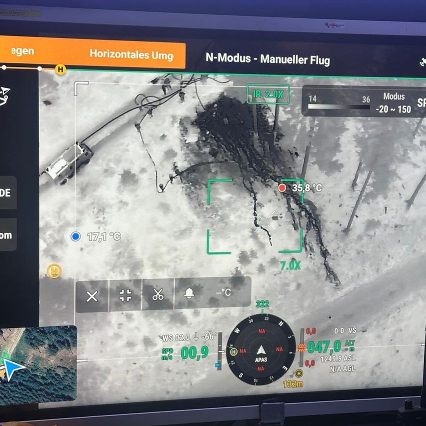 A screen displays a thermal imaging view with a vehicle and temperature readings. The interface shows various controls and data such as altitude, speed, and heading.