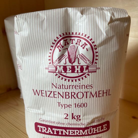 Ein Sack 'Matras Mehl' Weizenmehl, Typ 1600, mit einem Gewicht von 2 kg, auf einer Holzoberfläche. Das Mehl ist garantiert frei von chemischen Zusatzstoffen.
