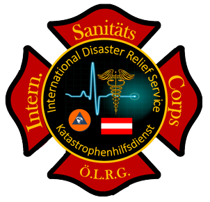 Das Logo des International Disaster Relief Service Corps zeigt ein rotes Sechseck mit 'Sanitäts' oben, 'International Disaster Relief Service' in der Mitte und 'Intern.' links. Das Logo enthält ein medizinisches Symbol und eine Flagge, umgeben von einem roten Rand.