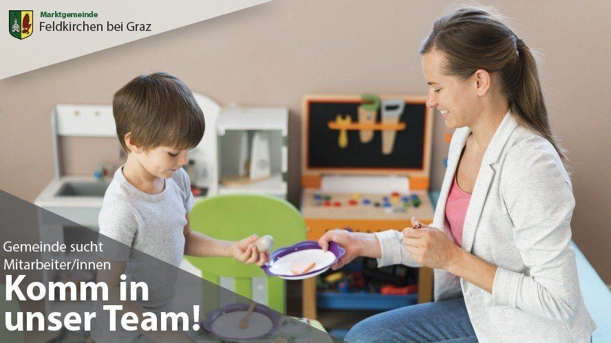 A woman and a young boy are sitting in a playroom. The boy is holding a spoon, and the woman is smiling. The woman is feeding the boy from a plate. The playroom has a wooden toy car and a toy kitchen. The text in the image reads 'We are looking for you in our team!'.
