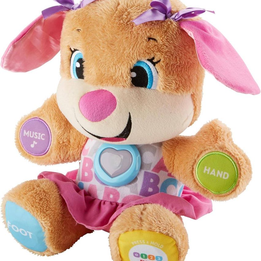 Ein Plüschspielzeug eines kleinen Kaninchens mit rosa Akzenten, blauen Augen und einem lächelnden Gesicht. Es hat interaktive Knöpfe an Hand und Fuß sowie einen herzförmigen Knopf auf der Brust.