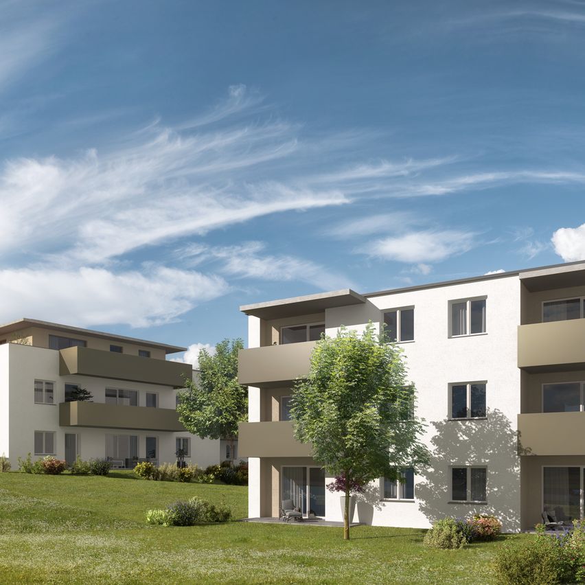 A rendering of modern apartment buildings in a suburban setting with lush green lawns and a clear blue sky.