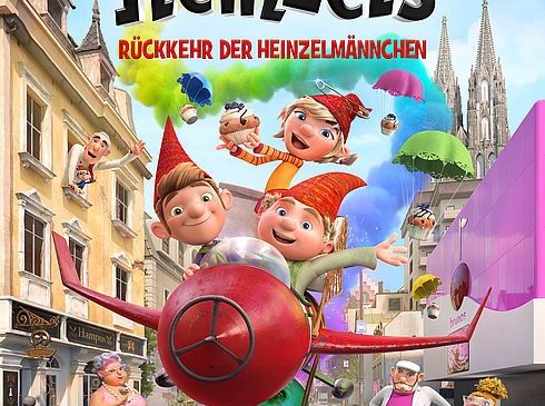 Filmplakat für 'Die Heinzels' zeigt animierte Charaktere, die über eine Stadt mit bunten Gebäuden fliegen und abspringen. Charaktere in Hüten und Kostümen scheinen in fröhlicher Stimmung zu sein.