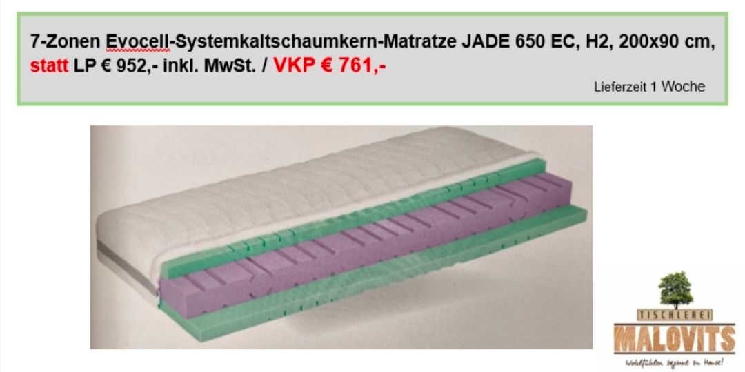 A mattress with a label above it that reads 'Evocell-Systemkaltschaumkern-Matratze JADE 650 EC, H2, 2952, incl. MwSt. / VKP € 761,-'. The mattress has a white top layer and a purple and green layer underneath.