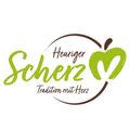 Ein Logo mit dem Wort 'Scherz' in grüner kursiver Schrift, einem Apfeldesign und dem Satz 'Heuriger Tradition mit Herz' darunter.