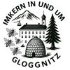 Das Gloggnitz-Logo mit einem Bienenstock, Bienen, einer Kirche und Bergen im Hintergrund.