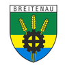 Das Breitenau Wappen zeigt einen Schild mit grün-gelb gestreiftem Hintergrund. Darauf abgebildet sind drei Weizenähren mit einer Zahnrad in der Mitte. Das Zahnrad ist schwarz und darunter befinden sich blaue und gelbe Streifen.