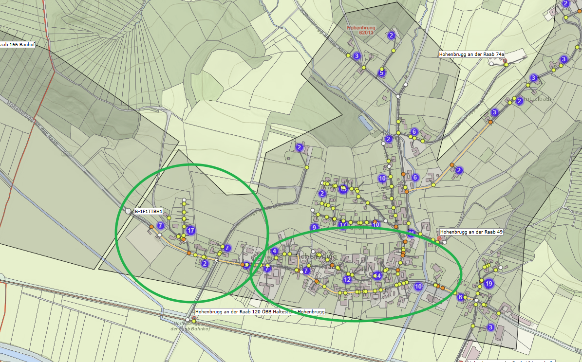 A map showing a town with numbered points and green circles highlighting specific areas. The map includes roads, buildings, and a railway.